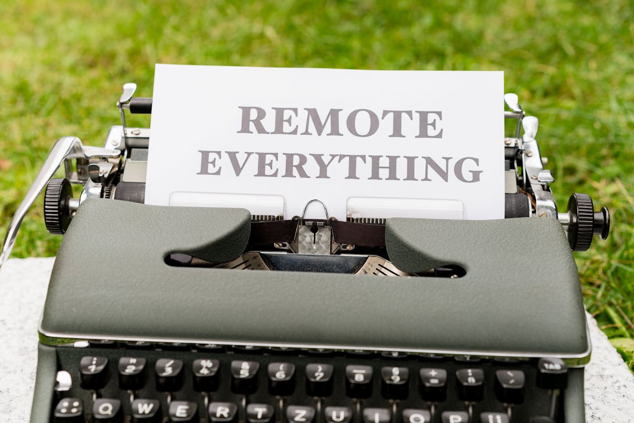 Retro typewriter displaying 'Remote Everything' in an outdoor setting, symbolizing digital transformation.
